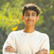 Portrait of happy teenage boy with arms crossed at park Portrait of happy teenage boy with arms crossed at park